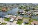 Waterfront property with a private dock, manicured lawn, and mature trees, within a scenic coastal community at 13909 Berkowitz Ave, Hudson, FL 34667