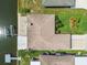 Aerial view of well-maintained home with lush landscaping, sprinkler system, and waterfront access at 13909 Berkowitz Ave, Hudson, FL 34667
