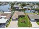 Waterfront home with a manicured lawn, swaying palms, a large driveway and convenient boat dock access at 13909 Berkowitz Ave, Hudson, FL 34667