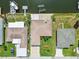 This aerial view shows a home with a boat dock, and a well-maintained yard at 13909 Berkowitz Ave, Hudson, FL 34667