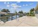 Exterior shot showcasing backyard, dock and boat lift and tranquil water views at 13909 Berkowitz Ave, Hudson, FL 34667