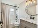 Bathroom features a marble countertop, stylish mirror and shower at 13909 Berkowitz Ave, Hudson, FL 34667