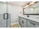 Bathroom features a glass enclosed shower and vanity with white marble top at 13909 Berkowitz Ave, Hudson, FL 34667