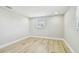 Empty bedroom featuring wood-look tile flooring and neutral paint at 13909 Berkowitz Ave, Hudson, FL 34667