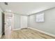 Bedroom with wood-look floors, a closet, and view to hallway at 13909 Berkowitz Ave, Hudson, FL 34667