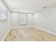 A bright, empty bedroom with wood-look floors, and two windows at 13909 Berkowitz Ave, Hudson, FL 34667
