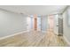 Bright bedroom featuring wood-look flooring and several doorways at 13909 Berkowitz Ave, Hudson, FL 34667