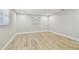 Neutral bedroom with wood-look tile flooring, white walls, and a window at 13909 Berkowitz Ave, Hudson, FL 34667