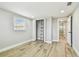 Bedroom features closet with shelving, wood-look tile flooring and lots of natural light at 13909 Berkowitz Ave, Hudson, FL 34667