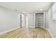 A bright bedroom featuring wood-look floors, and open closet at 13909 Berkowitz Ave, Hudson, FL 34667