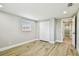 Bedroom features wood-look tile flooring, a window, and a closet with white folding doors at 13909 Berkowitz Ave, Hudson, FL 34667