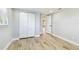 Bedroom with wood-look tile flooring and a closet with white folding doors at 13909 Berkowitz Ave, Hudson, FL 34667