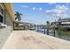 View of the boat lift from the dock and patio area, perfect for waterfront enthusiasts at 13909 Berkowitz Ave, Hudson, FL 34667