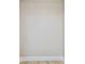 Empty neutral room with wood-look flooring and white trim at 13909 Berkowitz Ave, Hudson, FL 34667