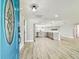 View from the entryway looking into an open floor plan, kitchen, and living area at 13909 Berkowitz Ave, Hudson, FL 34667
