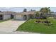 Charming single-story home with well-manicured lawn and attached one-car garage at 13909 Berkowitz Ave, Hudson, FL 34667