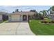 Charming single-story home with well-manicured lawn and attached one-car garage at 13909 Berkowitz Ave, Hudson, FL 34667