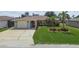 Charming single-story home with well-manicured lawn and attached one-car garage at 13909 Berkowitz Ave, Hudson, FL 34667