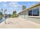 Exterior side view of the house, the canal, and the dockside patio at 13909 Berkowitz Ave, Hudson, FL 34667