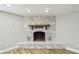 Stone fireplace features wooden mantle, recessed lighting, and a hearth at 13909 Berkowitz Ave, Hudson, FL 34667