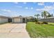 Well-maintained home with lush green lawn, mature palms, and charming curb appeal at 13909 Berkowitz Ave, Hudson, FL 34667