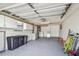 This spacious garage features white walls and cabinets and a painted gray floor at 13909 Berkowitz Ave, Hudson, FL 34667