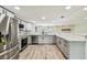 Well-lit kitchen showcasing stainless steel appliances, marble countertops, and ample cabinet space at 13909 Berkowitz Ave, Hudson, FL 34667
