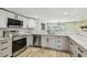 Stylish kitchen featuring stainless steel appliances, white subway tile, and marble countertops at 13909 Berkowitz Ave, Hudson, FL 34667