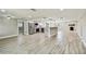 Modern kitchen boasts stainless steel appliances, white cabinetry, and open floorplan at 13909 Berkowitz Ave, Hudson, FL 34667
