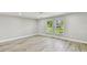 Spacious living room with wood floors, recessed lighting, and lots of natural light at 13909 Berkowitz Ave, Hudson, FL 34667