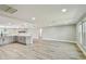 Open-concept living room features wood-look tile flooring and a stone fireplace at 13909 Berkowitz Ave, Hudson, FL 34667