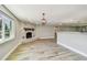 Spacious living room featuring a stone fireplace, light gray walls, and hardwood floors at 13909 Berkowitz Ave, Hudson, FL 34667