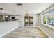 Bright living room features a sliding glass door to sunroom and views of the canal at 13909 Berkowitz Ave, Hudson, FL 34667
