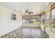 Enclosed patio with tiled floor, lots of natural light, and a ceiling fan at 13909 Berkowitz Ave, Hudson, FL 34667