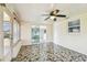 Enclosed patio with tiled floor, lots of natural light, and a ceiling fan at 13909 Berkowitz Ave, Hudson, FL 34667