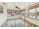 Enclosed patio with tiled floor, lots of natural light, and a ceiling fan at 13909 Berkowitz Ave, Hudson, FL 34667