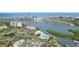 Aerial view of waterfront condo building with docks, tennis courts, and community pool at 14800 Walsingham Rd # 1215, Largo, FL 33774