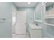 Bright bathroom featuring a marble countertop vanity, decorative mirror, and sleek fixtures at 14800 Walsingham Rd # 1215, Largo, FL 33774