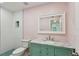 Colorful bathroom featuring a turquoise vanity, a mirror and turquoise tile shower at 14800 Walsingham Rd # 1215, Largo, FL 33774