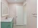 Charming bathroom with turquoise vanity, marble countertop, and a bright, clean aesthetic at 14800 Walsingham Rd # 1215, Largo, FL 33774