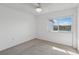 Bright, carpeted bedroom with a ceiling fan and view from the window at 14800 Walsingham Rd # 1215, Largo, FL 33774