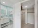 View into the closet, adjacent to the bathroom, with storage and rod for clothing at 14800 Walsingham Rd # 1215, Largo, FL 33774