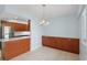 Dining area adjacent to the kitchen with stylish lighting at 14800 Walsingham Rd # 1215, Largo, FL 33774