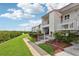 Exterior view of condo featuring a balcony and well-maintained landscaping at 14800 Walsingham Rd # 1215, Largo, FL 33774
