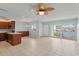 Open-concept kitchen & living space with waterfront views from sliding glass doors and wood cabinets at 14800 Walsingham Rd # 1215, Largo, FL 33774