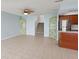 Open living area showcasing tile floors, green cabinets, stairs, and stainless steel appliances at 14800 Walsingham Rd # 1215, Largo, FL 33774
