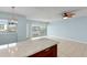 Open living area with sliding glass door with water views and kitchen bar at 14800 Walsingham Rd # 1215, Largo, FL 33774