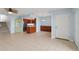Open-concept living space featuring tile floors, kitchen access, and natural light at 14800 Walsingham Rd # 1215, Largo, FL 33774