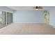 Bright living room featuring tile flooring, sliding glass doors, and a unique decorative cabinet at 14800 Walsingham Rd # 1215, Largo, FL 33774