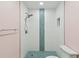 Modern walk-in shower with patterned accent tiling and mosaic tile floor at 14800 Walsingham Rd # 1215, Largo, FL 33774